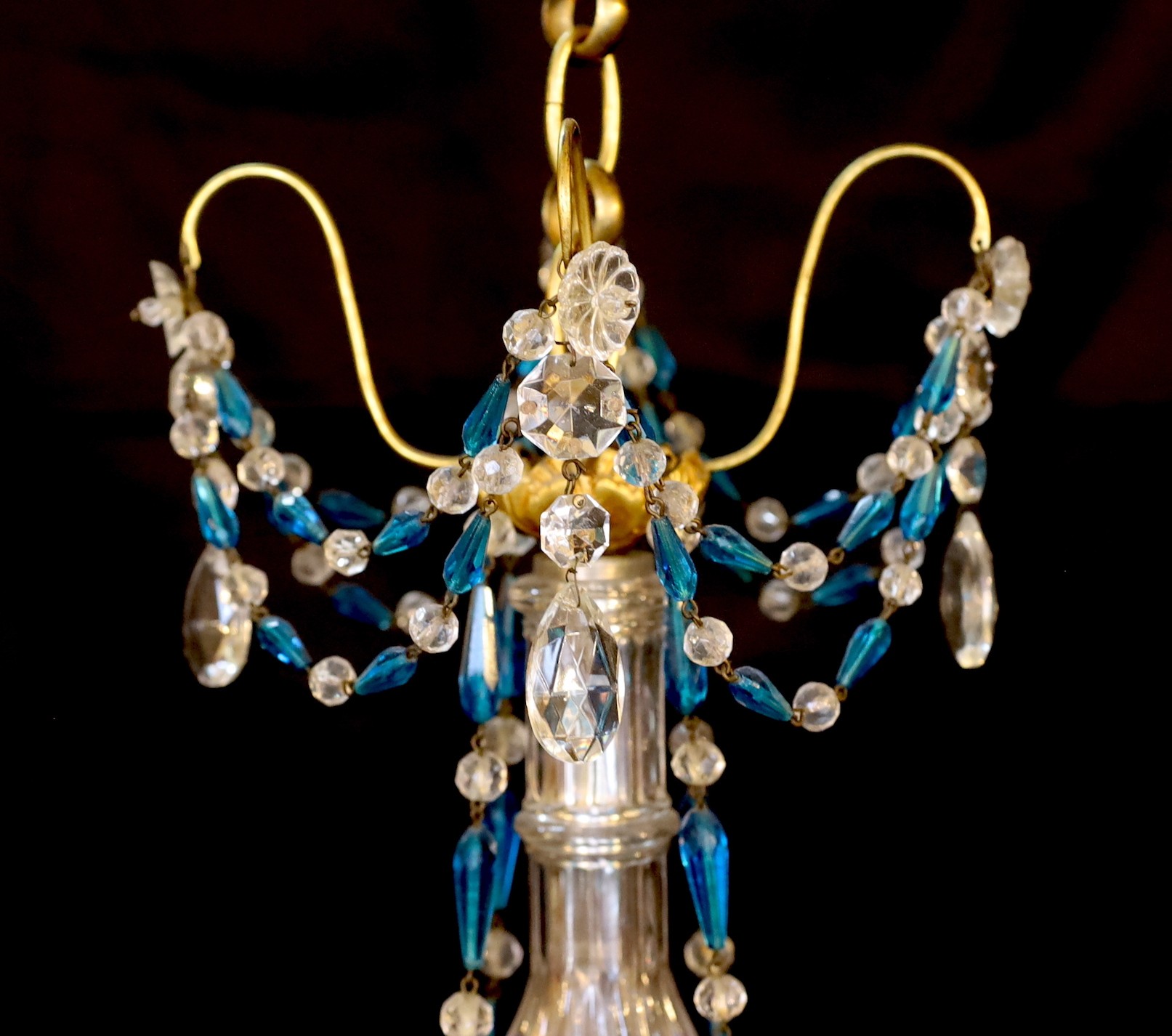 An early 20th century French gilt brass clear and blue glass four light chandelier, drop 80cm. width 40cm